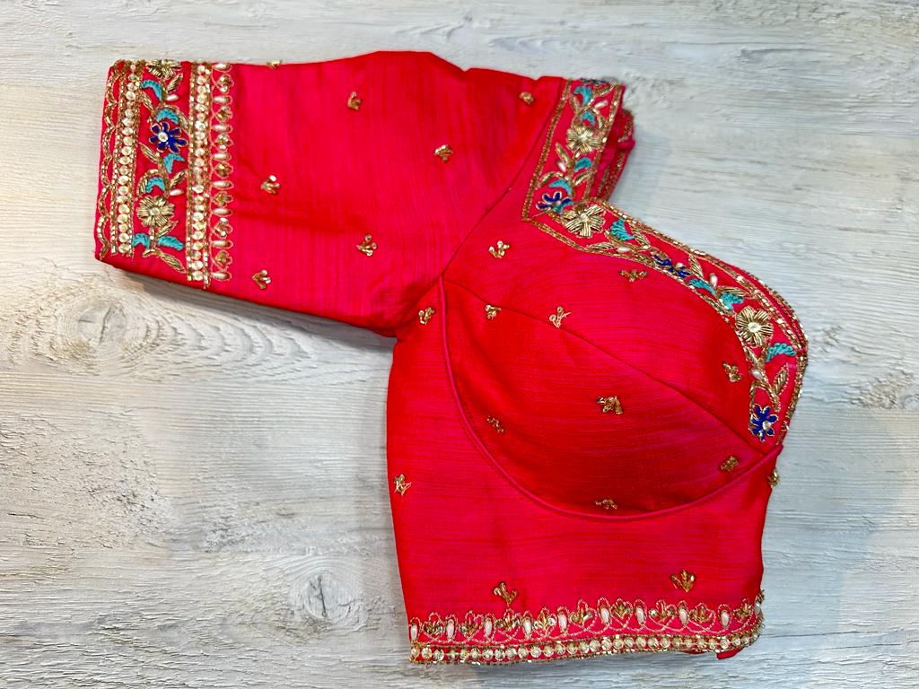 Buy red embroidered blouse features cut dana and stone embroidery on the edges and stylish back. Make a fashion statement on festive occasions and weddings with designer blouses, designer sarees, designer suits, Indian dresses, designer gowns, sharara suits, and embroidered sarees from Pure Elegance Indian fashion store in the USA.