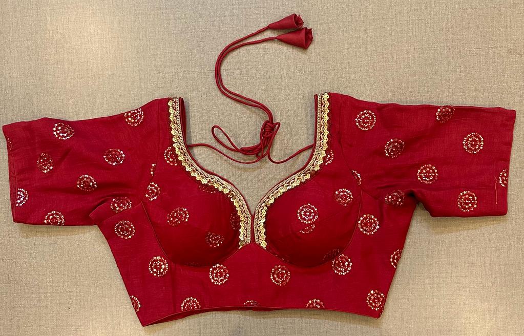 Buy a red blouse with sequin embroidered patches and short sleeves. Make a fashion statement on festive occasions and weddings with designer blouses, designer sarees, designer suits, Indian dresses, designer gowns, sharara suits, and embroidered sarees from Pure Elegance Indian fashion store in the USA.