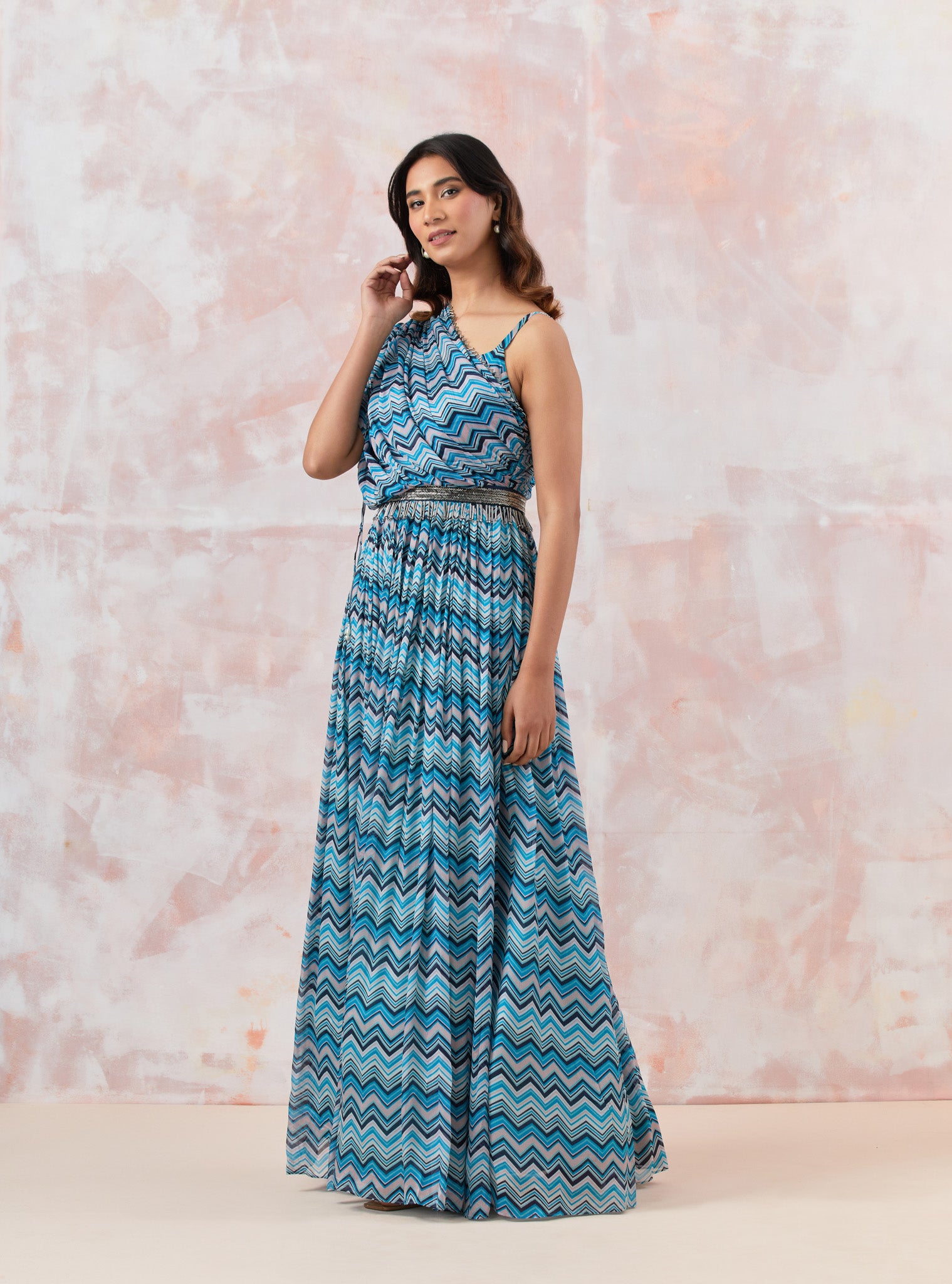 Buy a Blue stylish gown dress crafted in the softest Chinon fabric. the draped neckline brings in glamour. Dazzle on weddings and special occasions with exquisite Indian designer dresses, sharara suits, Anarkali suits, and wedding lehengas from Pure Elegance Indian fashion store in the USA.