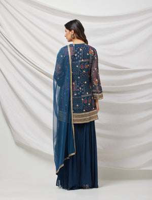 Buy teal blue sharara set featuring Kurta with foil work, shells, and coin detailing, also plain sharara  It is best for occasions & parties. Dazzle on weddings and special occasions with exquisite Indian designer dresses, sharara suits, Anarkali suits, and wedding lehengas from Pure Elegance Indian fashion store in the USA.