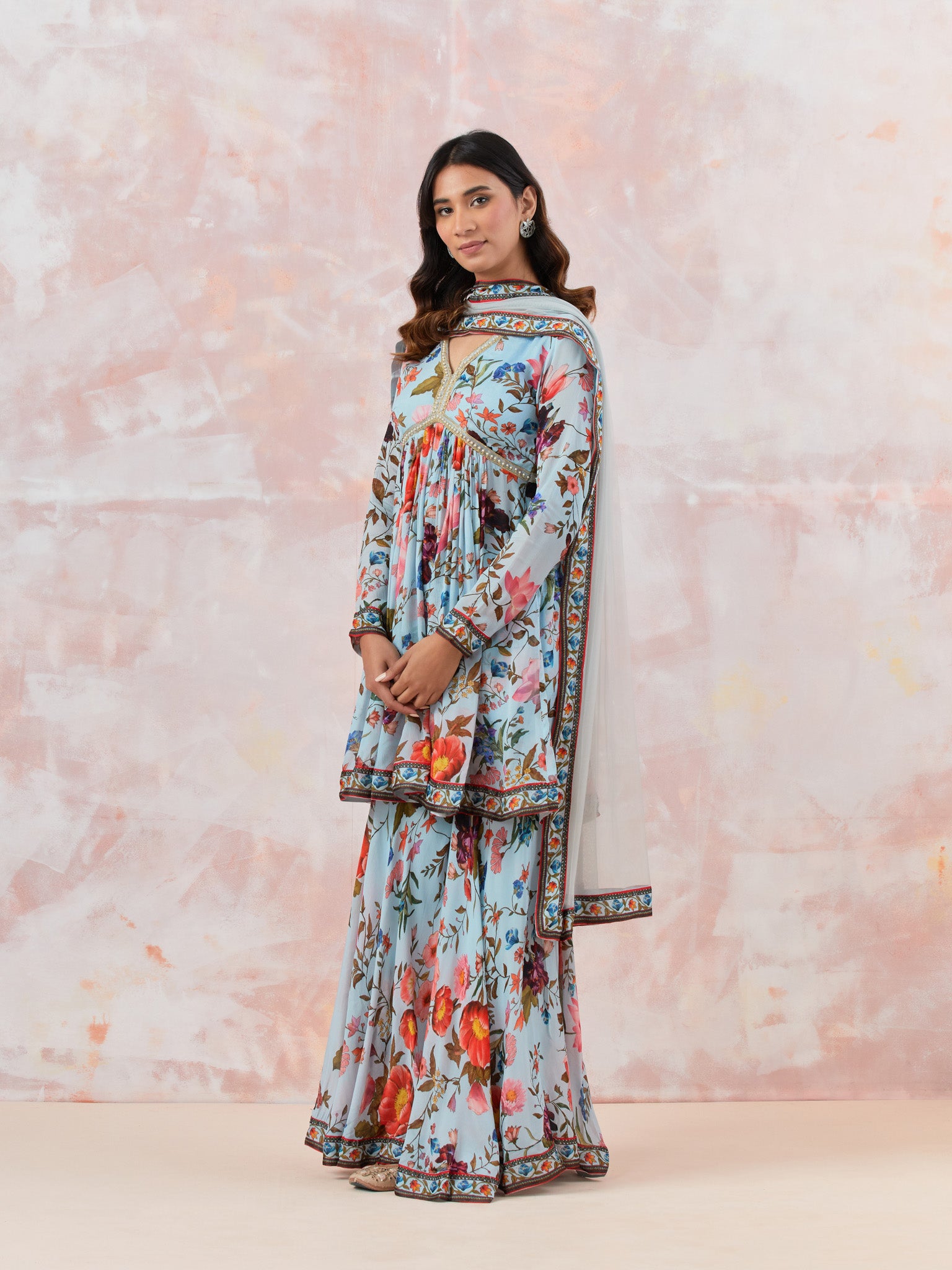Buy a Blue Floral silk sharara suit set featuring Kurta with bead & cut dana work, V-neck, paired with sharara bottom and net dupatta. Dazzle on weddings and special occasions with exquisite Indian designer dresses, sharara suits, Anarkali suits, and wedding lehengas from Pure Elegance Indian fashion store in the USA.