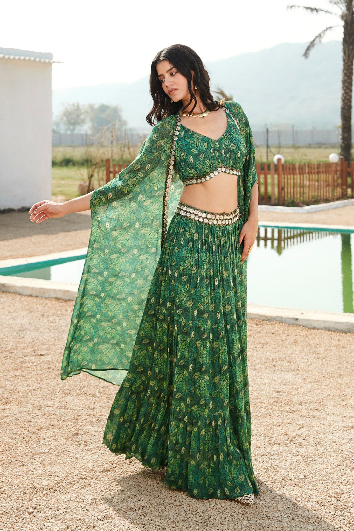 Buy a green printed skirt set adorned with a v- neck blouse & printed cape. Dazzle on weddings and special occasions with exquisite Indian designer dresses, sharara suits, Anarkali suits, and wedding lehengas from Pure Elegance Indian fashion store in the USA.