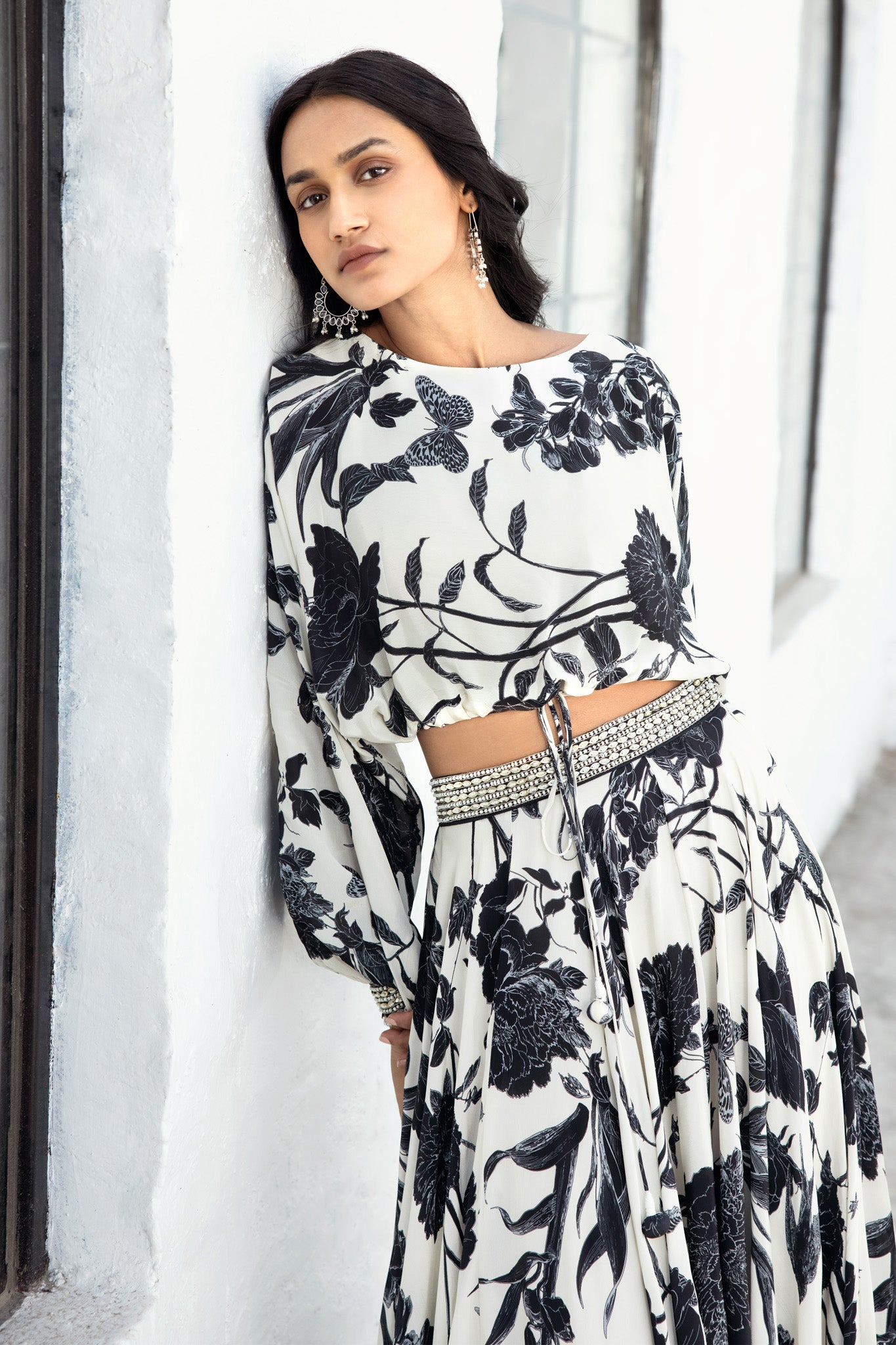 Buy Black & white crepe skirt set adorned with hand-embroidered sequins. Dazzle on weddings and special occasions with exquisite Indian designer dresses, sharara suits, Anarkali suits, and wedding lehengas from Pure Elegance Indian fashion store in the USA.