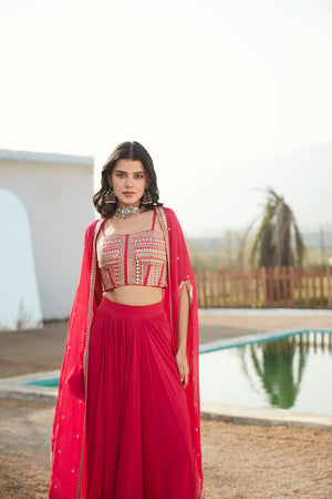 Buy rani pink skirt set adorned with a corset blouse & cape. Dazzle on weddings and special occasions with exquisite Indian designer dresses, sharara suits, Anarkali suits, and wedding lehengas from Pure Elegance Indian fashion store in the USA.