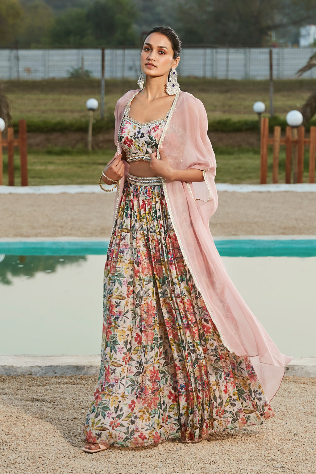 Buy a Pink sharara set adorned with a stylish cape. Dazzle on weddings and special occasions with exquisite Indian designer dresses, sharara suits, Anarkali suits, and wedding lehengas from Pure Elegance Indian fashion store in the USA.