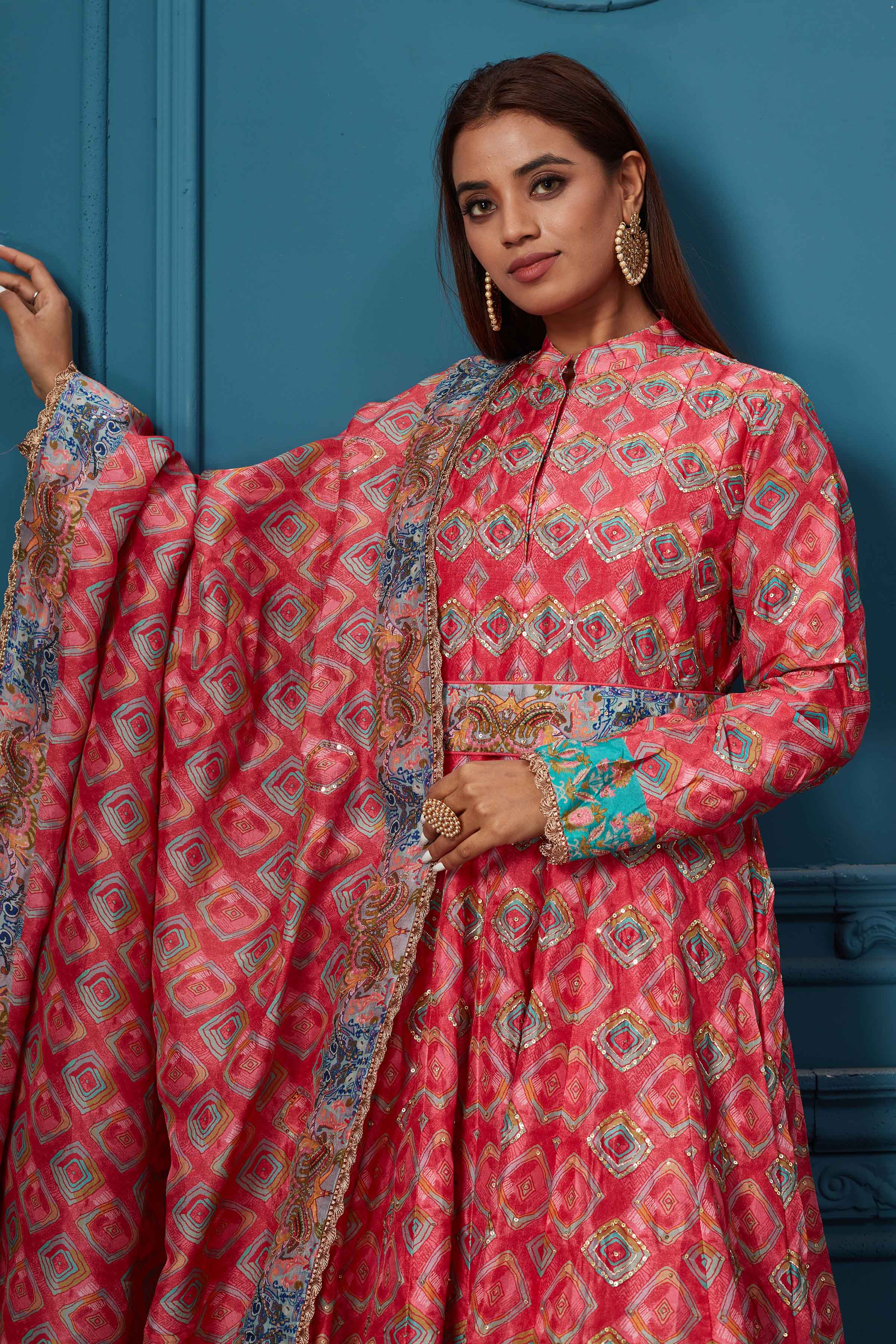 Shop a gorgeous red blue multicolored printed anarkali suit set with embroidery. Featuring a beautiful belt, collar neck, full-length sleeves, and a stylish dupatta. Shop online at Pure Elegance or visit our store in the USA.