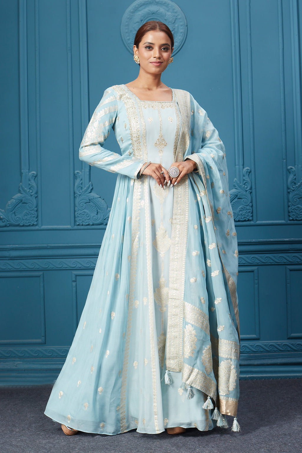 Shop light blue embroidered full sleeves Anarkali suit featuring embroidery, and tassel work dupatta. Dazzle on special occasions with exquisite Indian designer dresses, sharara suits, Anarkali suits, bridal lehengas, and sharara suits from Pure Elegance Indian clothing store in the USA. Shop online from Pure Elegance.