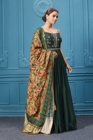 Shop a dark green embroidered sleeveless Anarkali suit with a floral mustard dupatta. Dazzle on special occasions with exquisite Indian designer dresses, sharara suits, Anarkali suits, bridal lehengas, and sharara suits from Pure Elegance Indian clothing store in the USA. Shop online from Pure Elegance.