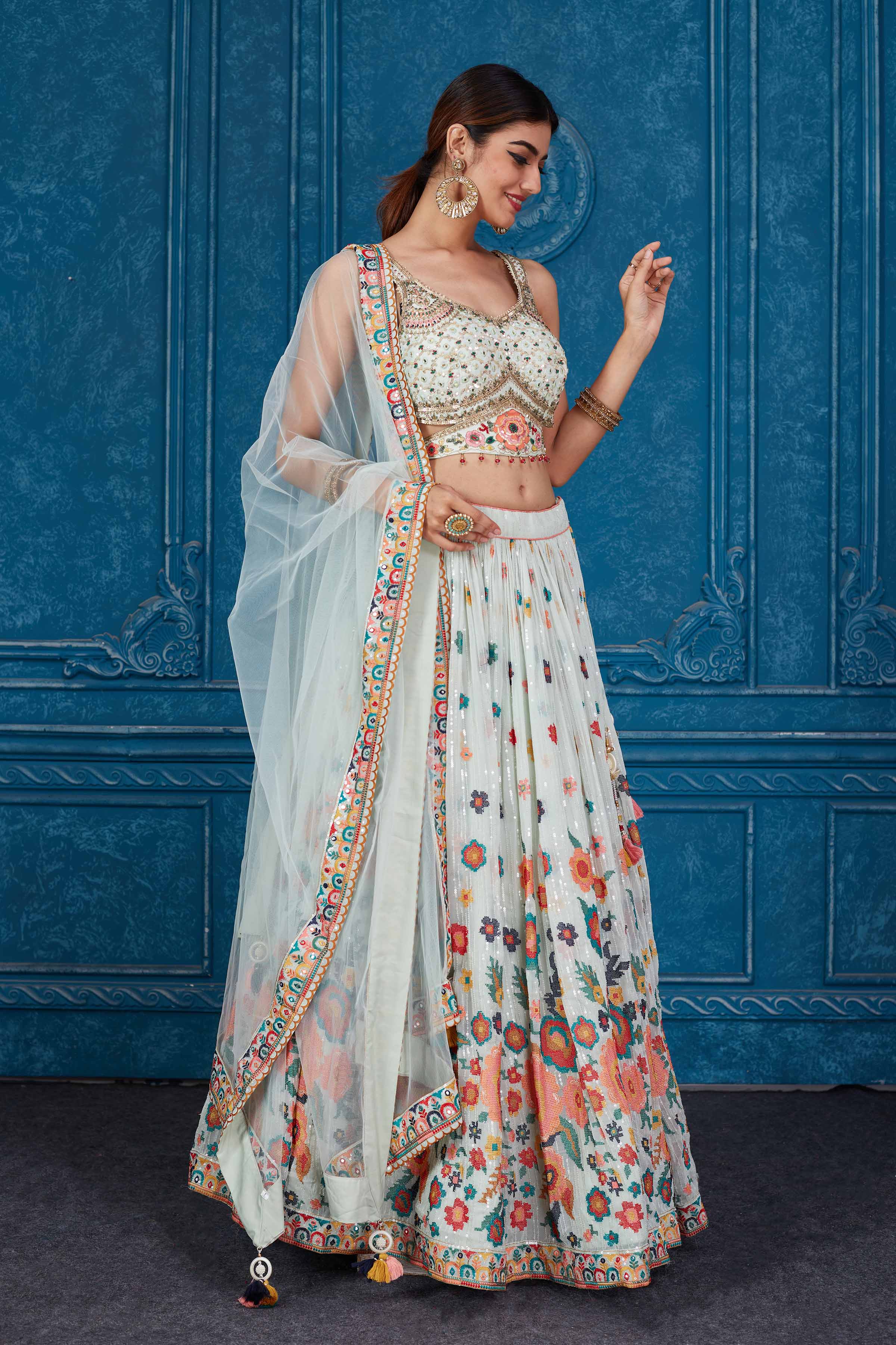 Shop stunning mint green floral embroidered georgette lehenga online in USA with dupatta. Slay in style at wedding festivities in this beautiful designer lehengas. hand embroidered lehengas, Bollywood lehenga, Anarkali suits, sharara suits from Pure Elegance Indian saree store in USA. -side