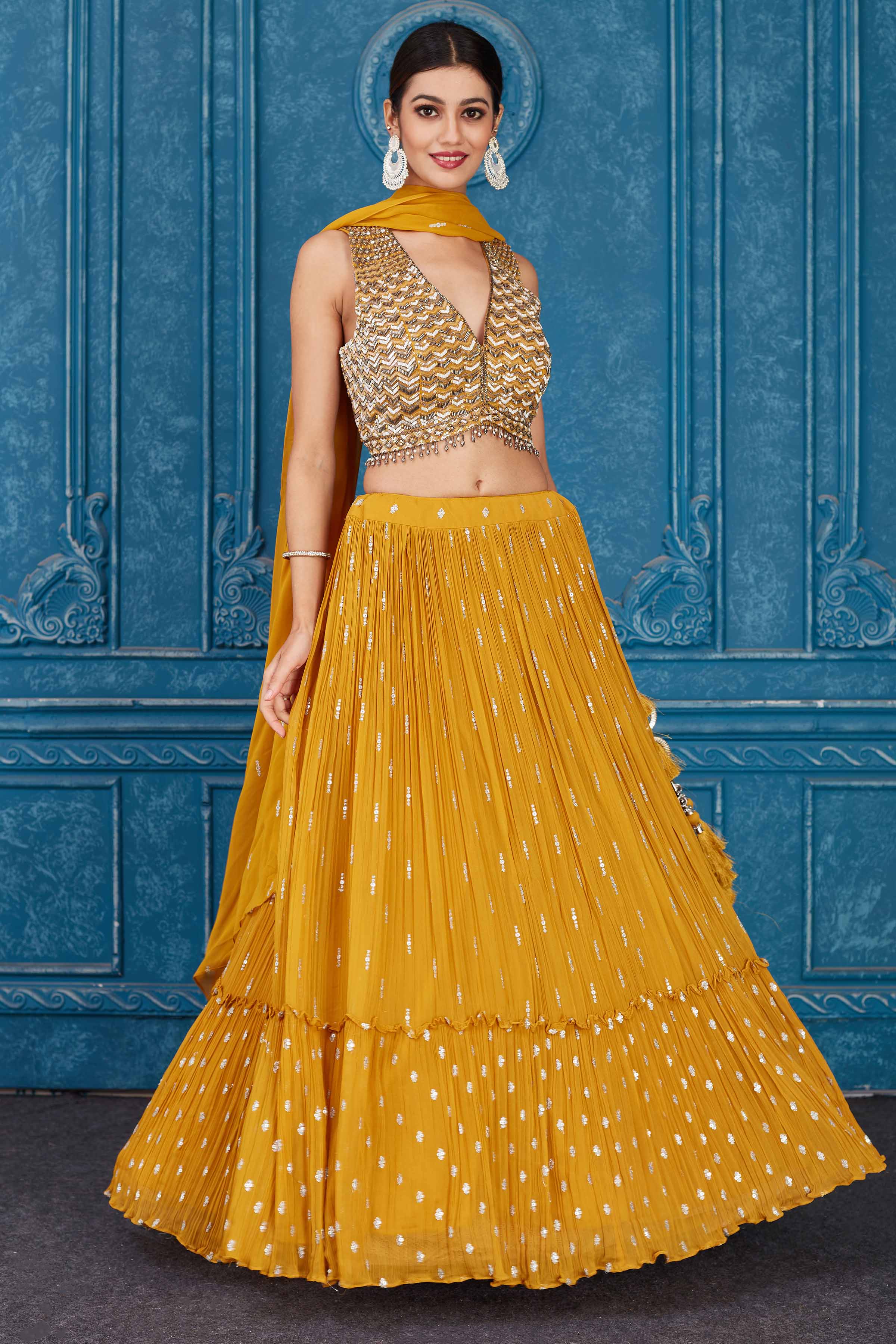 Shop beautiful mustard embroidered georgette lehenga online in USA with dupatta. Slay in style at wedding festivities in this beautiful designer lehengas. hand embroidered lehengas, Bollywood lehenga, Anarkali suits, sharara suits from Pure Elegance Indian saree store in USA. -side