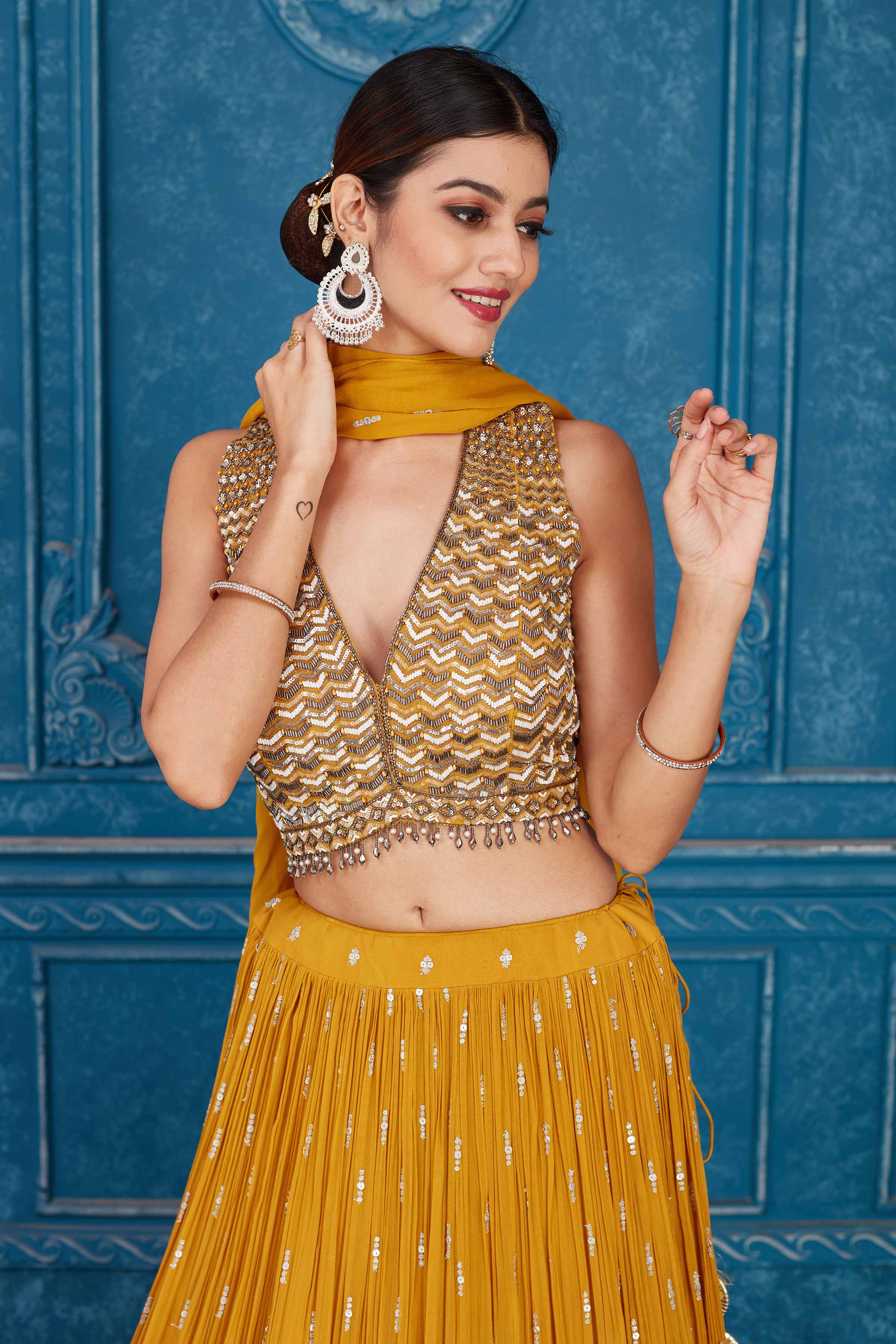 Shop beautiful mustard embroidered georgette lehenga online in USA with dupatta. Slay in style at wedding festivities in this beautiful designer lehengas. hand embroidered lehengas, Bollywood lehenga, Anarkali suits, sharara suits from Pure Elegance Indian saree store in USA. -closeup