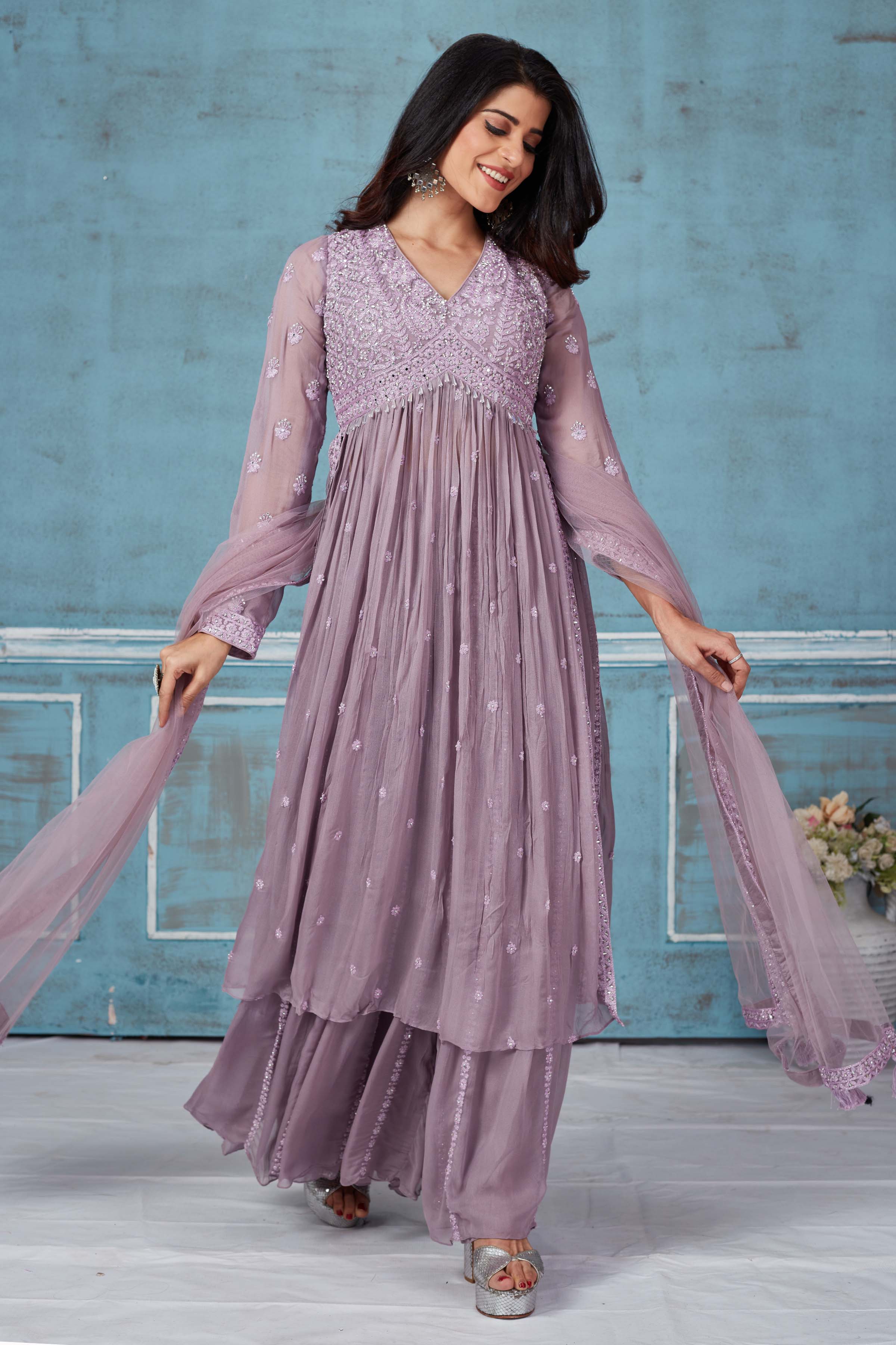 Buy lavender embroidered georgette palazzo suit online in USA with dupatta. Look royal on special occasions in exquisite designer lehengas, pure silk sarees, handloom sarees, Bollywood sarees, Anarkali suits, Banarasi sarees, organza sarees from Pure Elegance Indian saree store in USA.-front