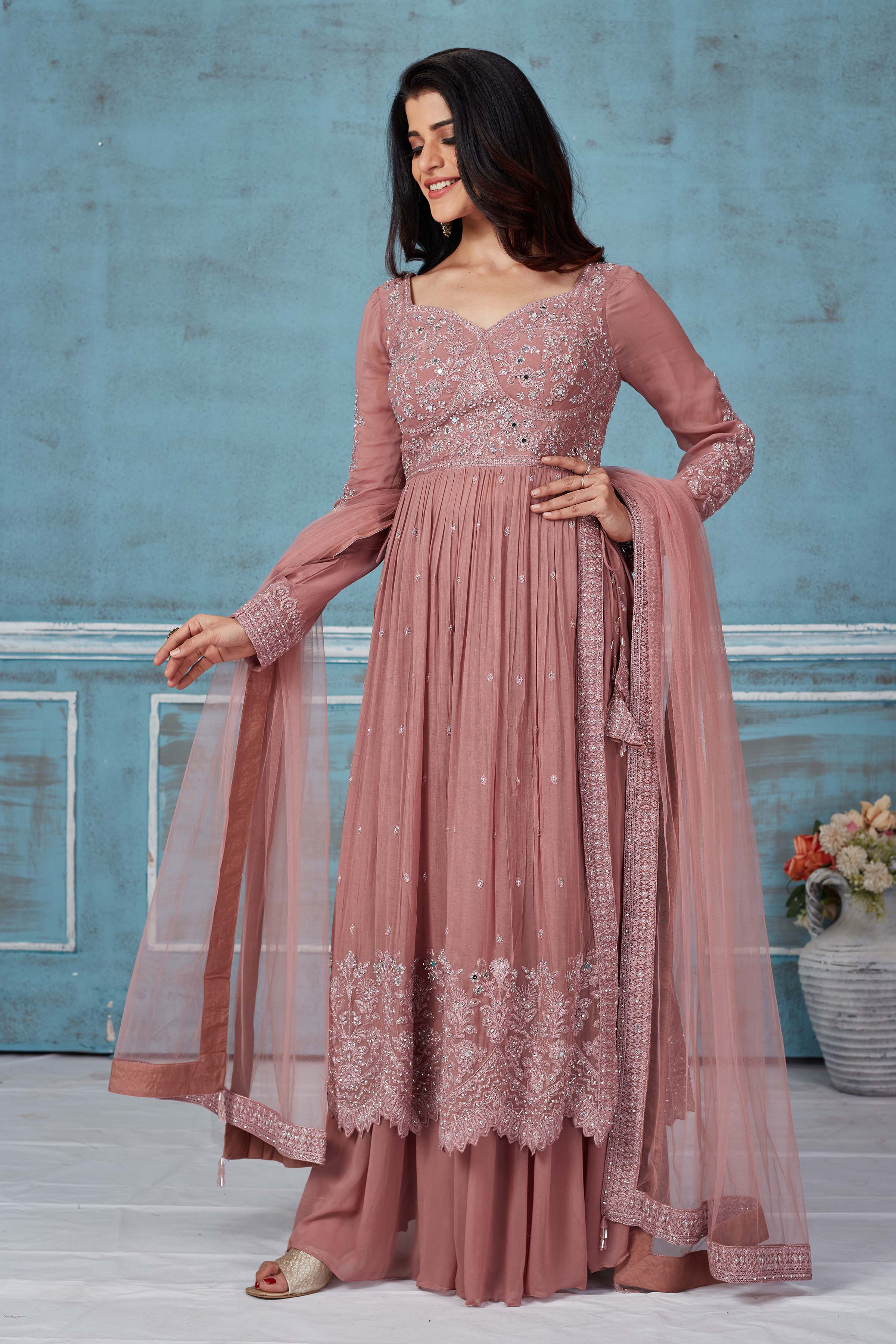 Buy dusty pink embroidered georgette palazzo suit online in USA with dupatta. Look royal on special occasions in exquisite designer lehengas, pure silk sarees, handloom sarees, Bollywood sarees, Anarkali suits, Banarasi sarees, organza sarees from Pure Elegance Indian saree store in USA.-front