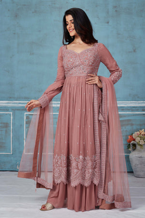 Buy dusty pink embroidered georgette palazzo suit online in USA with dupatta. Look royal on special occasions in exquisite designer lehengas, pure silk sarees, handloom sarees, Bollywood sarees, Anarkali suits, Banarasi sarees, organza sarees from Pure Elegance Indian saree store in USA.-front