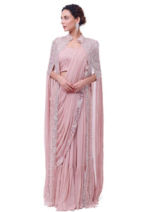 Buy light pink georgette saree online in USA with tasseled cape. Look your best at parties and weddings in beautiful designer sarees, embroidered sarees, handwoven sarees, silk sarees, organza saris from Pure Elegance Indian saree store in USA.-full view