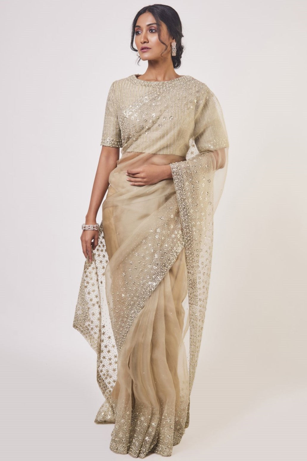 Shop beige organza saree online in USA with stone, cutdana and pearl work. Look your best at parties and weddings in beautiful designer sarees, embroidered sarees, handwoven sarees, silk sarees, organza saris from Pure Elegance Indian saree store in USA.-full view