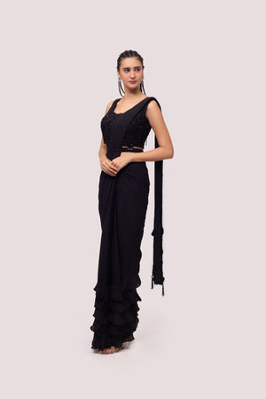 Shop black pre-draped georgette saree online in USA with soft ruffles. Look your best at parties and weddings in beautiful designer sarees, embroidered sarees, handwoven sarees, silk sarees, organza saris from Pure Elegance Indian saree store in USA.-saree