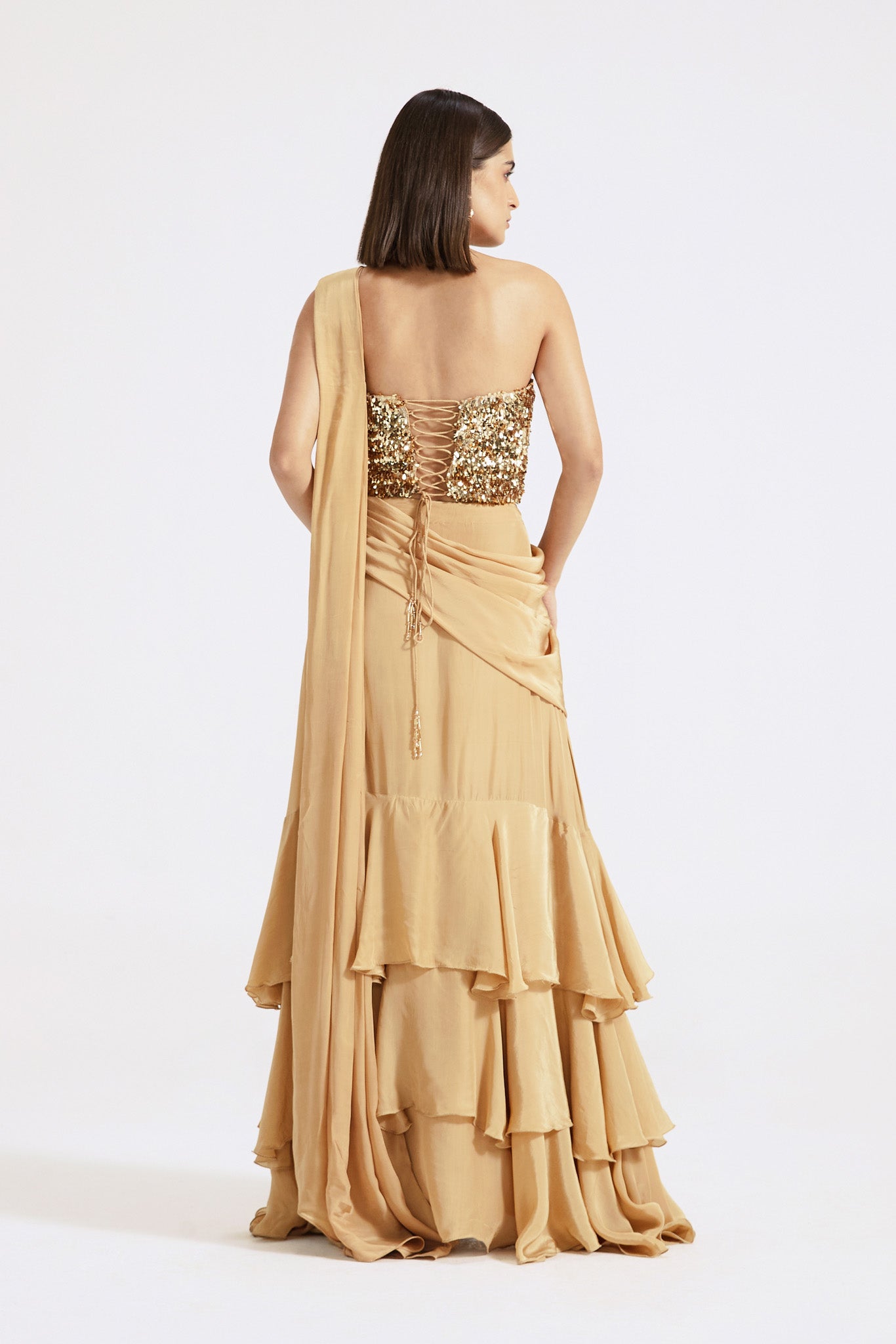 Buy gold georgette pre-draped saree online in USA with sequin blouse. Look your best at parties and weddings in beautiful designer sarees, embroidered sarees, handwoven sarees, silk sarees, organza saris from Pure Elegance Indian saree store in USA.-back