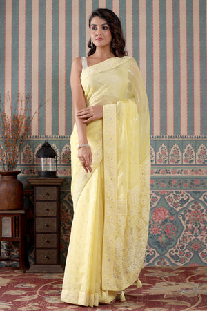 Buy lemon yellow embroidered georgette saree online in USA. Make a fashion statement at weddings with stunning designer sarees, embroidered sarees with blouse, wedding sarees, handloom sarees from Pure Elegance Indian fashion store in USA.-side