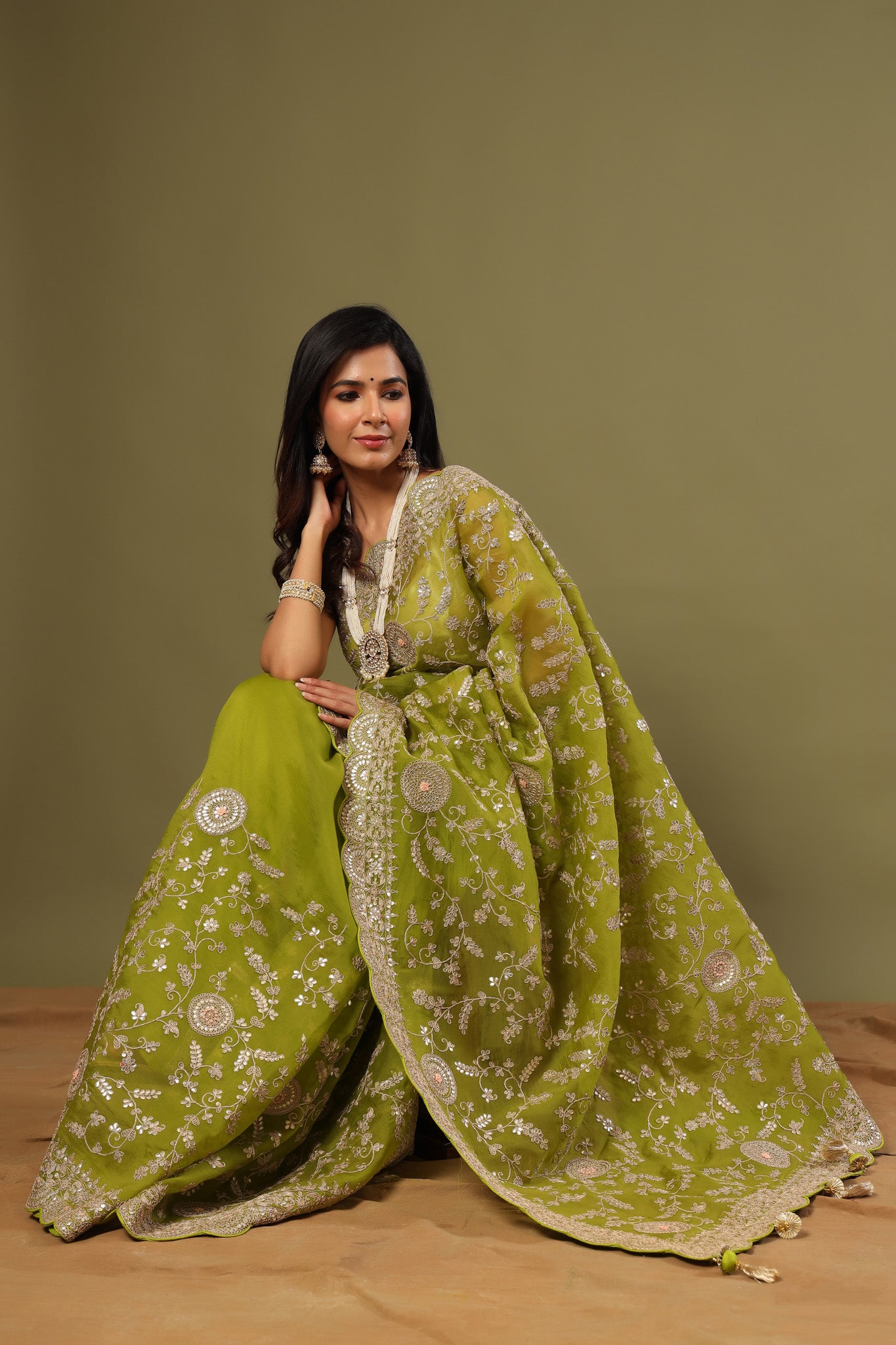 Buy beautiful olive green organza saree online in USA with embroidery. Make a fashion statement at weddings with stunning designer sarees, embroidered sarees with blouse, wedding sarees, handloom sarees from Pure Elegance Indian fashion store in USA.-closeup