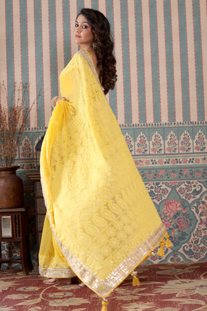 Buy yellow georgette Lucknowi sari online in USA with gota work border. Make a fashion statement at weddings with stunning designer sarees, embroidered sarees with blouse, wedding sarees, handloom sarees from Pure Elegance Indian fashion store in USA.-pallu