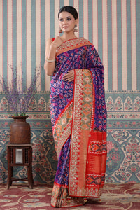 Buy purple Patola silk sari online in USA with red embroidered border. Make a fashion statement at weddings with stunning designer sarees, embroidered sarees with blouse, wedding sarees, handloom sarees from Pure Elegance Indian fashion store in USA.-full view