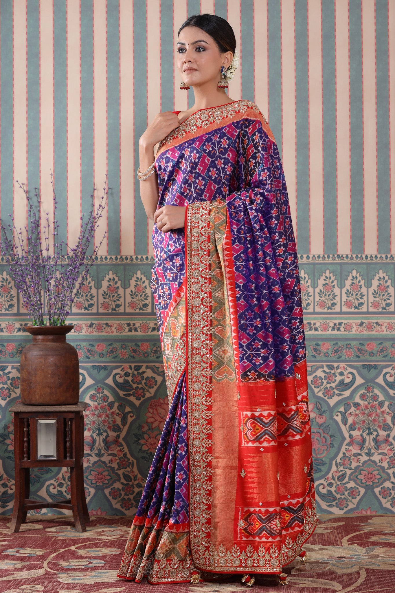 Buy purple Patola silk sari online in USA with red embroidered border. Make a fashion statement at weddings with stunning designer sarees, embroidered sarees with blouse, wedding sarees, handloom sarees from Pure Elegance Indian fashion store in USA.-side