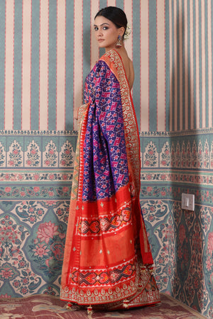 Buy purple Patola silk sari online in USA with red embroidered border. Make a fashion statement at weddings with stunning designer sarees, embroidered sarees with blouse, wedding sarees, handloom sarees from Pure Elegance Indian fashion store in USA.-pallu