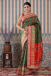Shop green Patola silk sari online in USA with red embroidered border. Make a fashion statement at weddings with stunning designer sarees, embroidered sarees with blouse, wedding sarees, handloom sarees from Pure Elegance Indian fashion store in USA.-full view