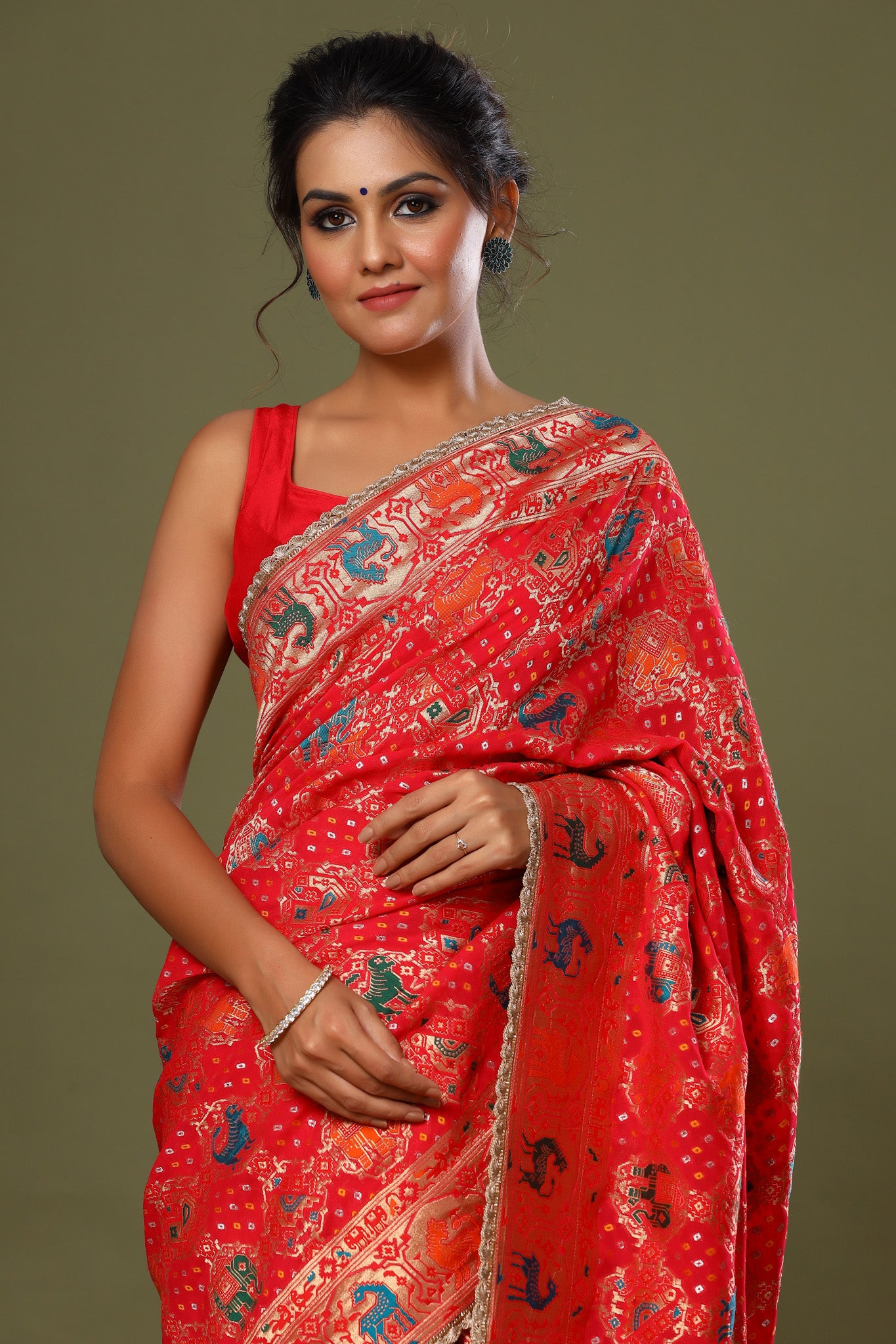 Shop red Patola silk saree online in USA with golden scalloped lace. Make a fashion statement at weddings with stunning designer sarees, embroidered sarees with blouse, wedding sarees, handloom sarees from Pure Elegance Indian fashion store in USA.-closeup