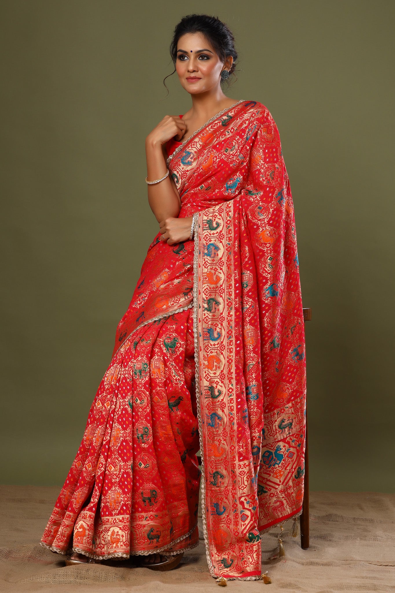 Shop red Patola silk saree online in USA with golden scalloped lace. Make a fashion statement at weddings with stunning designer sarees, embroidered sarees with blouse, wedding sarees, handloom sarees from Pure Elegance Indian fashion store in USA.-saree