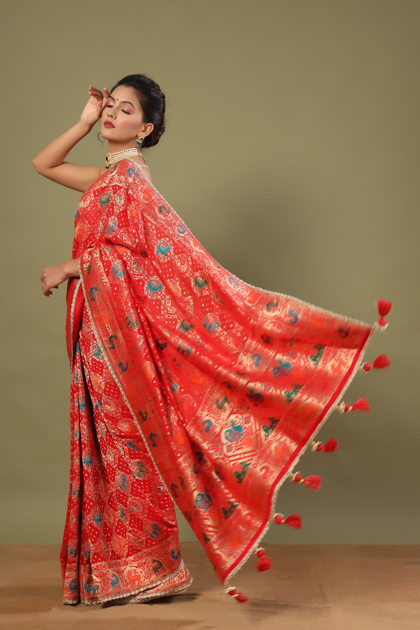 Shop red Patola silk saree online in USA with golden scalloped lace. Make a fashion statement at weddings with stunning designer sarees, embroidered sarees with blouse, wedding sarees, handloom sarees from Pure Elegance Indian fashion store in USA.-pallu