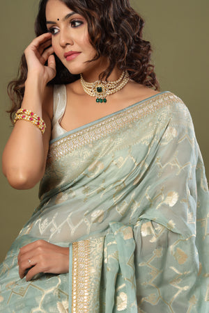 Shop mint green Banarasi saree online in USA with embroidered border. Make a fashion statement at weddings with stunning designer sarees, embroidered sarees with blouse, wedding sarees, handloom sarees from Pure Elegance Indian fashion store in USA.-closeup