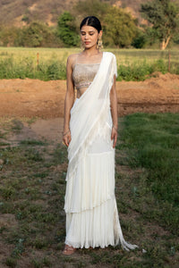 Buy white georgette saree accentuated by fringes. Dazzle on weddings and special occasions with exquisite Indian designer dresses, sharara suits, Anarkali suits, and wedding lehengas from Pure Elegance Indian fashion store in the USA.