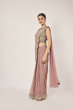 Shop peach drape saree set. Make a fashion statement on festive occasions and weddings with designer sarees, designer suits, Indian dresses, Anarkali suits, palazzo suits, designer gowns, sharara suits, and embroidered sarees from Pure Elegance Indian fashion store in the USA.