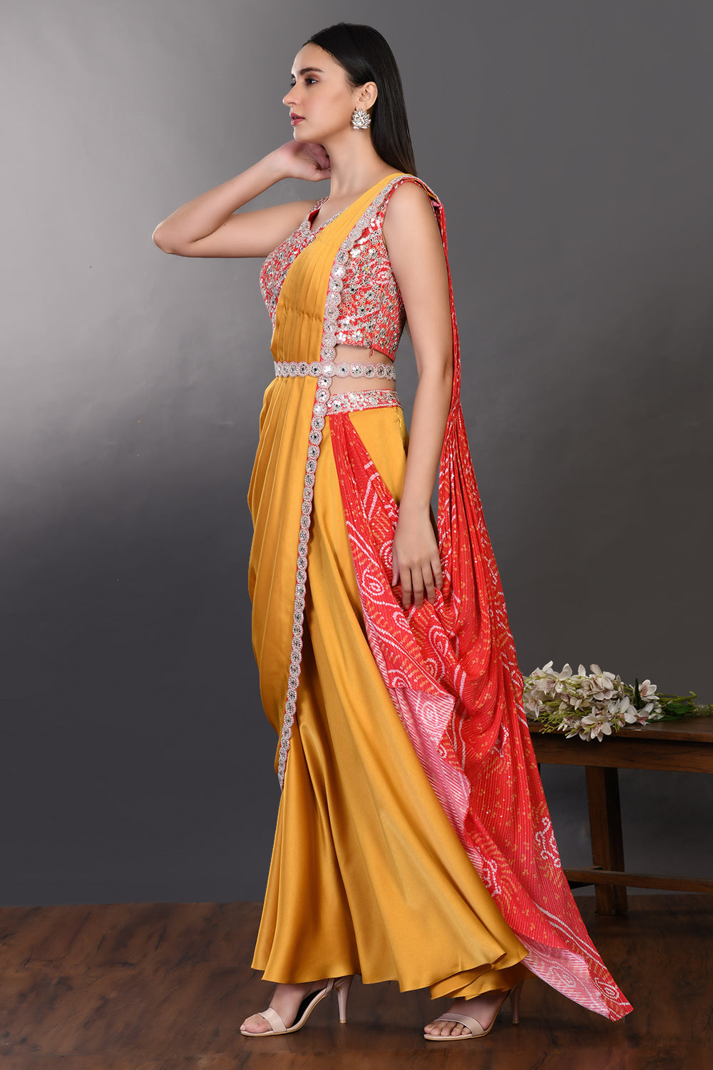 Shop mustard and red drape saree with embroidered blouse and belt. Make a fashion statement on festive occasions and weddings with designer sarees, designer suits, Indian dresses, Anarkali suits, palazzo suits, designer gowns, sharara suits, and embroidered sarees from Pure Elegance Indian fashion store in the USA.