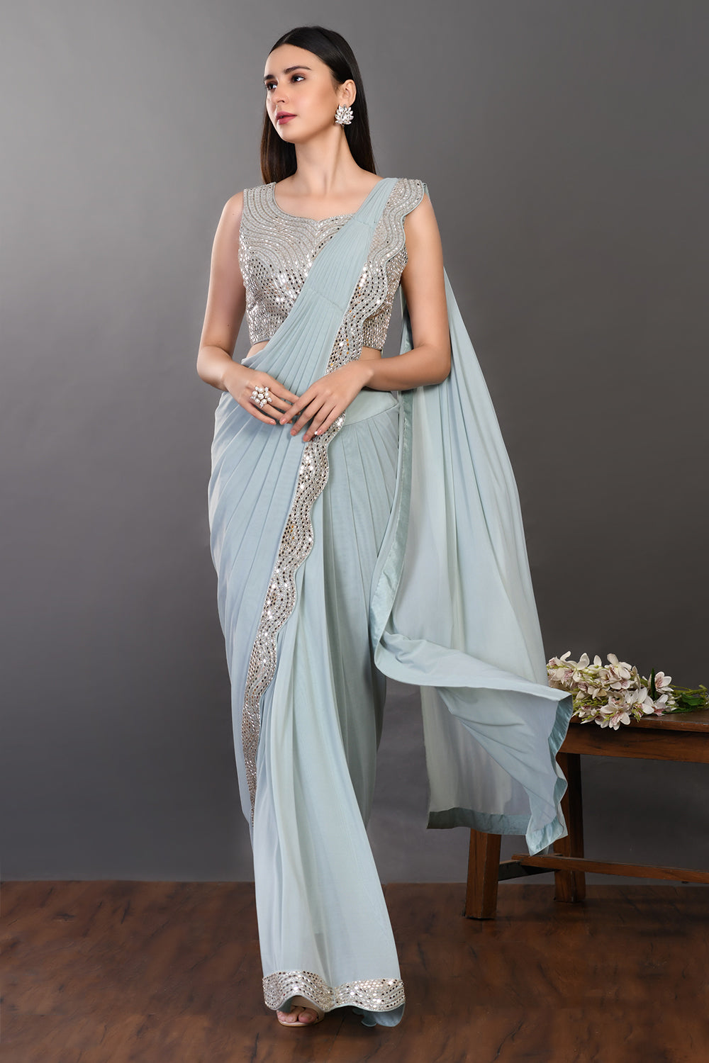 Shop a blue drape saree with embroidered blouse. Make a fashion statement on festive occasions and weddings with designer sarees, designer suits, Indian dresses, Anarkali suits, palazzo suits, designer gowns, sharara suits, and embroidered sarees from Pure Elegance Indian fashion store in the USA.