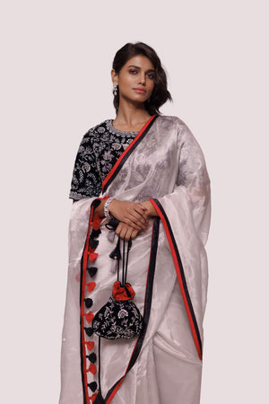 Buy silver tissue saree online in USA with black embroidered saree blouse. Look your best at parties and weddings in beautiful designer sarees, embroidered sarees, handwoven sarees, silk sarees, organza saris from Pure Elegance Indian saree store in USA.-closeup