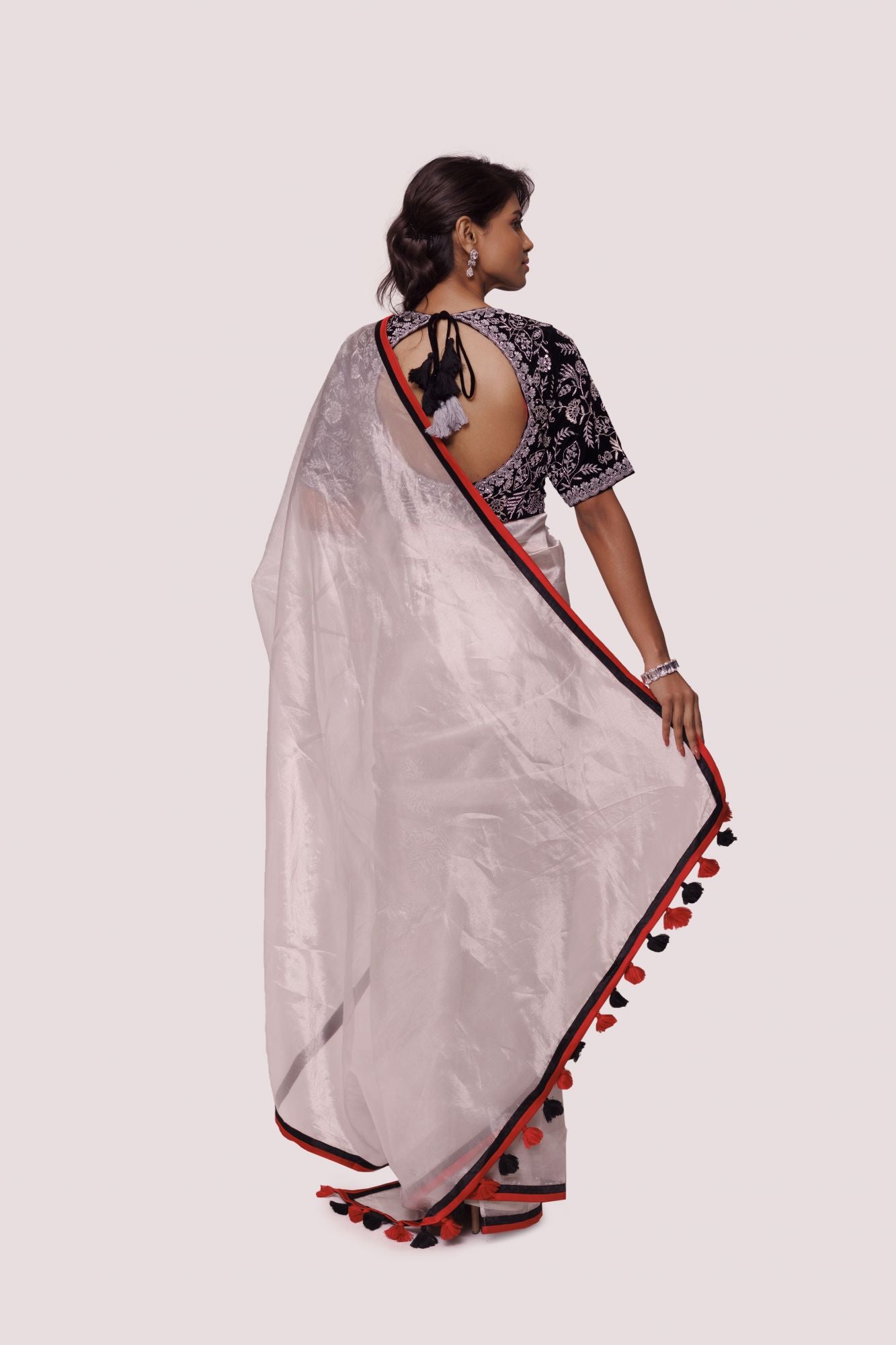 Buy silver tissue saree online in USA with black embroidered saree blouse. Look your best at parties and weddings in beautiful designer sarees, embroidered sarees, handwoven sarees, silk sarees, organza saris from Pure Elegance Indian saree store in USA.-back
