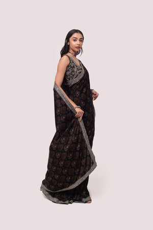 Shop a Beautiful mehndi green velvet saree featuring dark-toned motifs embellished edges and cheed, sequin work. It comes with a highly decorative blouse. Make a fashion statement on festive occasions and weddings with designer sarees, designer suits, Indian dresses, Anarkali suits, palazzo suits, designer gowns, sharara suits, and embroidered sarees from Pure Elegance Indian fashion store in the USA.