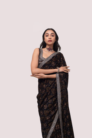 Shop a Beautiful mehndi green velvet saree featuring dark-toned motifs embellished edges and cheed, sequin work. It comes with a highly decorative blouse. Make a fashion statement on festive occasions and weddings with designer sarees, designer suits, Indian dresses, Anarkali suits, palazzo suits, designer gowns, sharara suits, and embroidered sarees from Pure Elegance Indian fashion store in the USA.