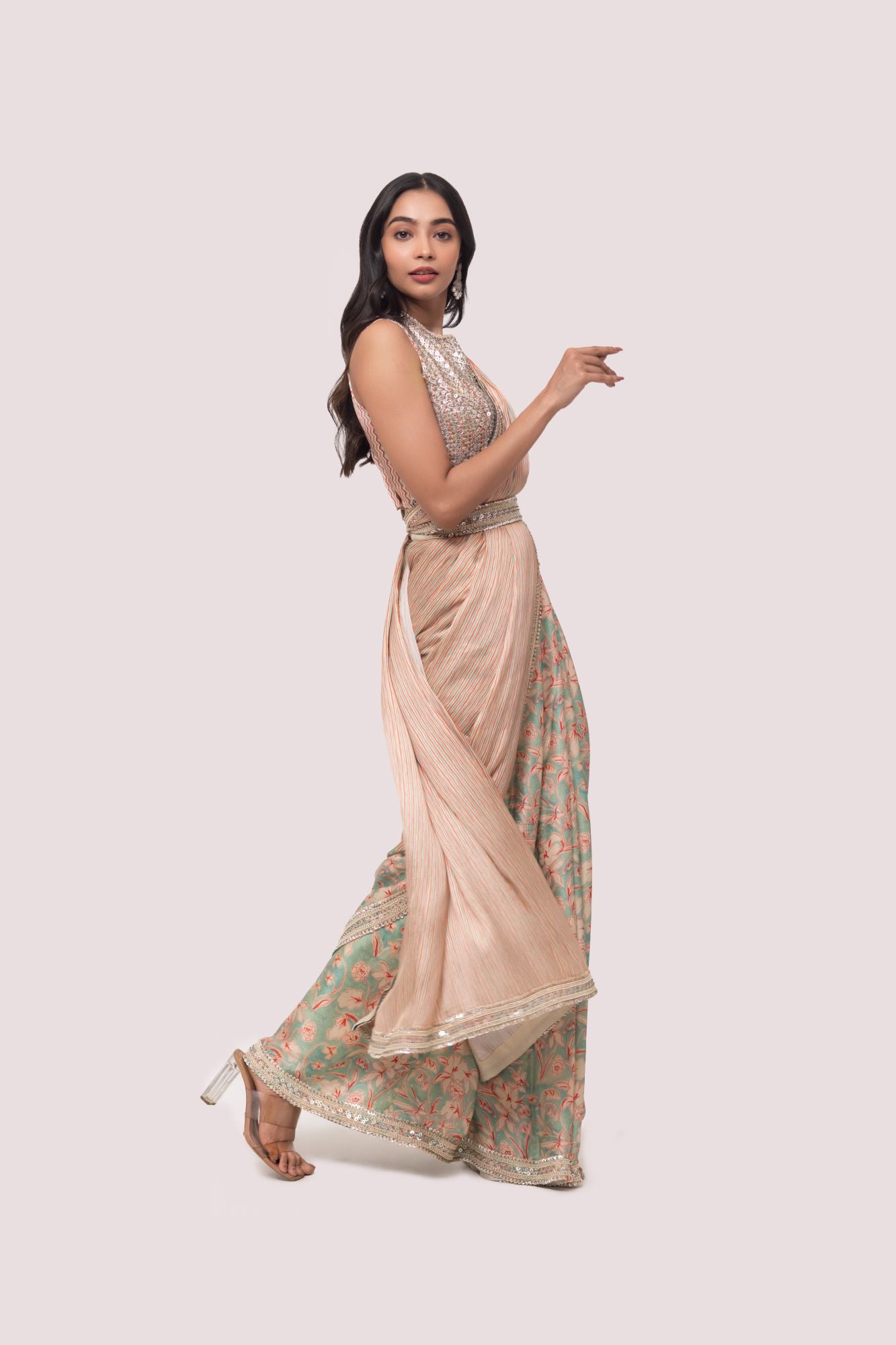 Shop a beautiful multicolored floral saree featuring sequin and cheed work. It comes with a heavily embroidered full-back sleeveless blouse.  Make a fashion statement on festive occasions and weddings with designer sarees, designer suits, Indian dresses, Anarkali suits, palazzo suits, designer gowns, sharara suits, and embroidered sarees from Pure Elegance Indian fashion store in the USA.