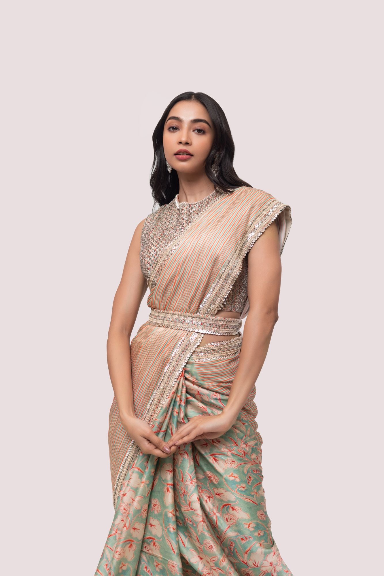 Shop a beautiful multicolored floral saree featuring sequin and cheed work. It comes with a heavily embroidered full-back sleeveless blouse.  Make a fashion statement on festive occasions and weddings with designer sarees, designer suits, Indian dresses, Anarkali suits, palazzo suits, designer gowns, sharara suits, and embroidered sarees from Pure Elegance Indian fashion store in the USA.