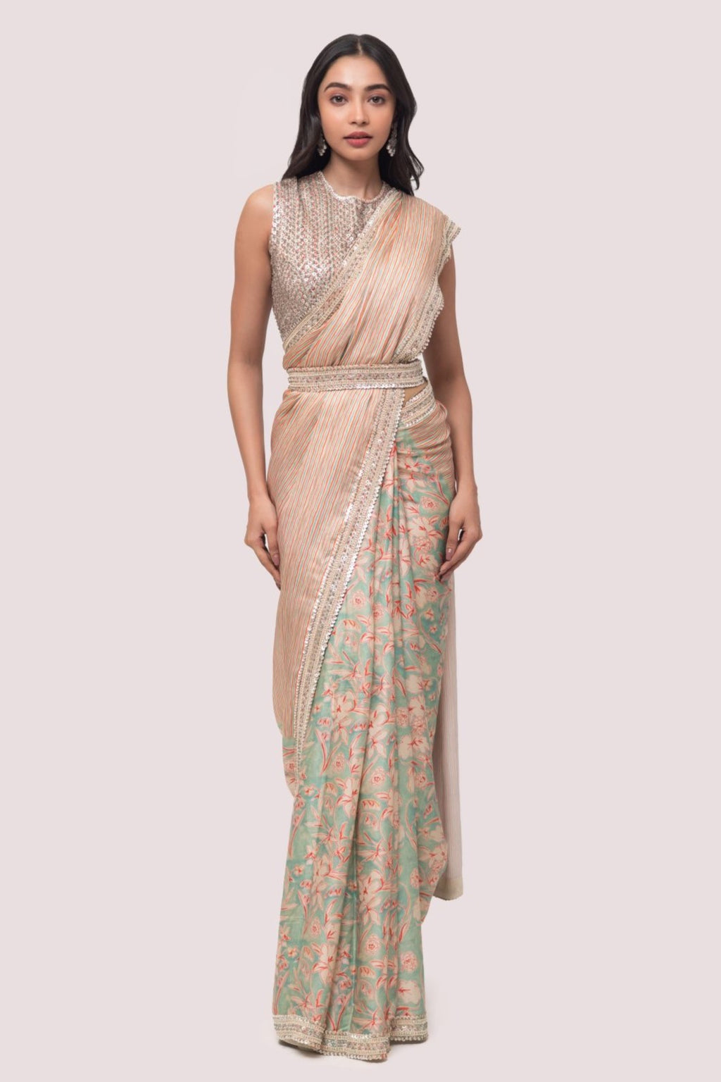 Shop a beautiful multicolored floral saree featuring sequin and cheed work. It comes with a heavily embroidered full-back sleeveless blouse.  Make a fashion statement on festive occasions and weddings with designer sarees, designer suits, Indian dresses, Anarkali suits, palazzo suits, designer gowns, sharara suits, and embroidered sarees from Pure Elegance Indian fashion store in the USA.