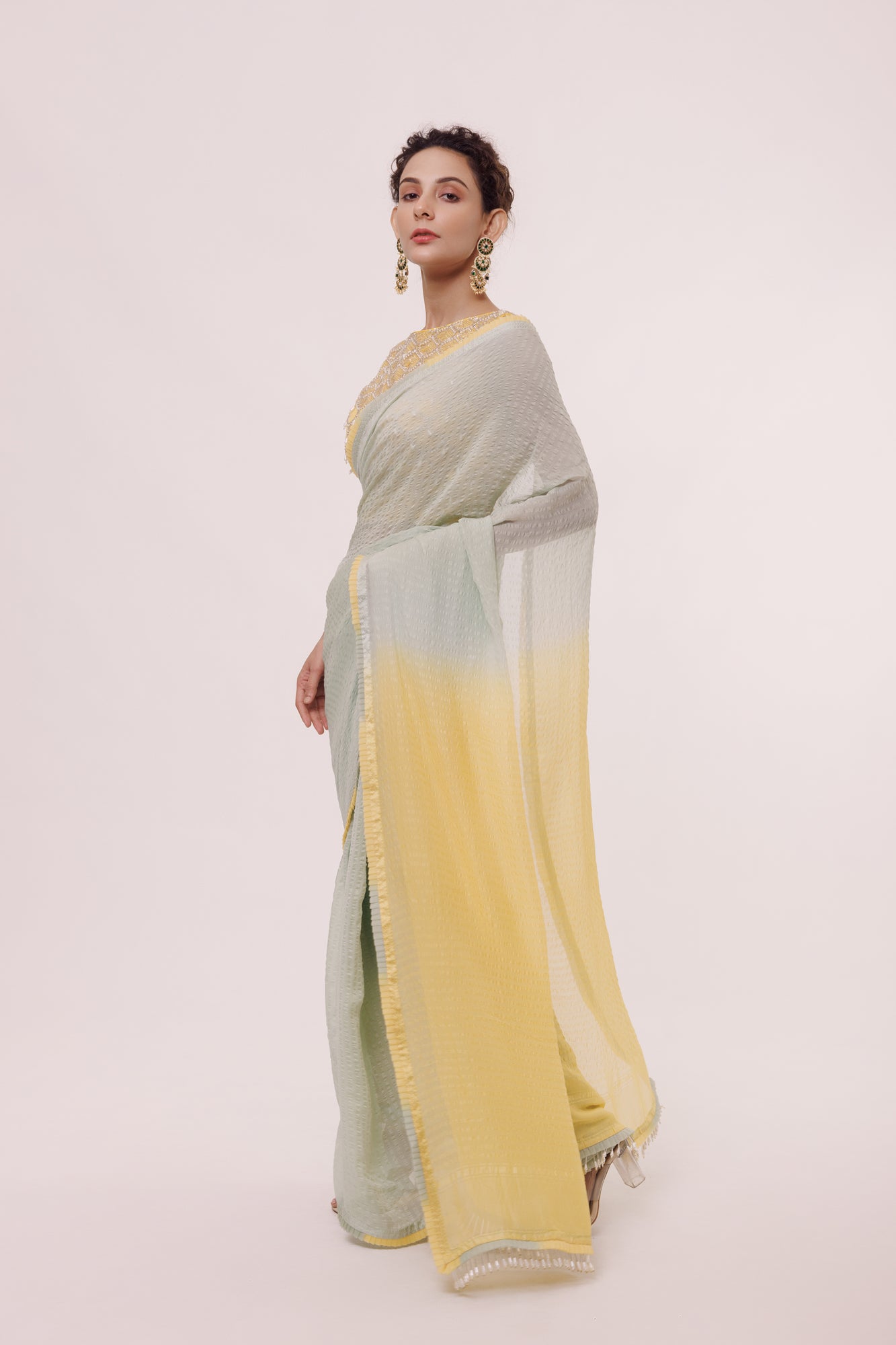 Shop a grey and lemon yellow dual-toned saree embellished with Tikki. Make a fashion statement on festive occasions and weddings with designer sarees, designer suits, Indian dresses, Anarkali suits, palazzo suits, designer gowns, sharara suits, and embroidered sarees from Pure Elegance Indian fashion store in the USA.