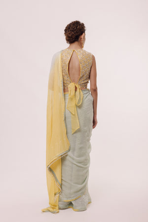 Shop a grey and lemon yellow dual-toned saree embellished with Tikki. Make a fashion statement on festive occasions and weddings with designer sarees, designer suits, Indian dresses, Anarkali suits, palazzo suits, designer gowns, sharara suits, and embroidered sarees from Pure Elegance Indian fashion store in the USA.