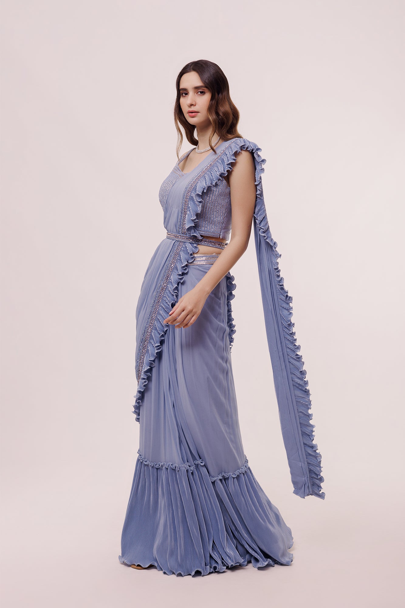 Shop the blue pre-stiched ruffle saree with a designer blouse. Make a fashion statement on festive occasions and weddings with designer sarees, designer suits, Indian dresses, Anarkali suits, palazzo suits, designer gowns, sharara suits, and embroidered sarees from Pure Elegance Indian fashion store in the USA.