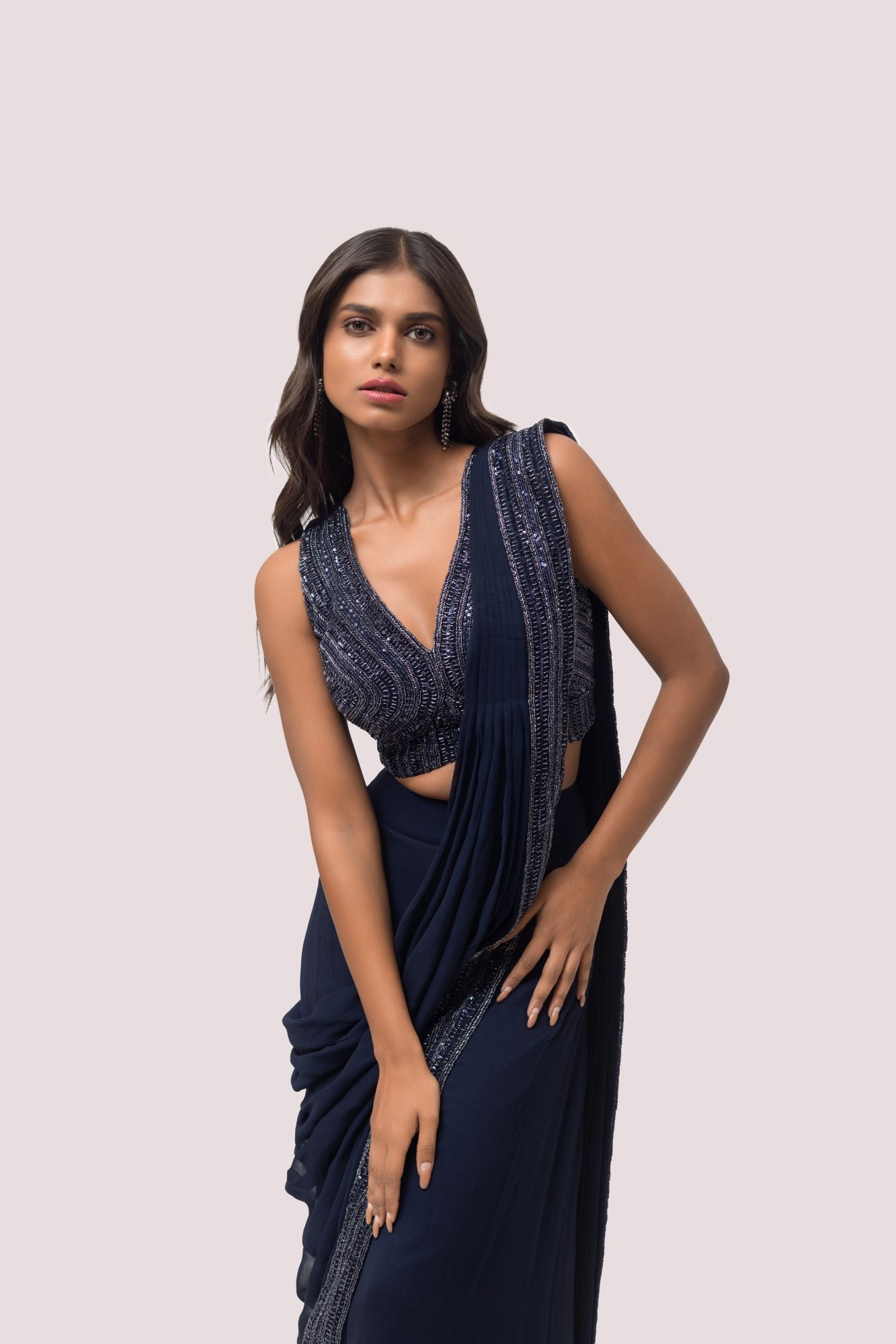 Shop the navy blue ruffle saree with sleeveless blouse. Make a fashion statement on festive occasions and weddings with designer sarees, designer suits, Indian dresses, Anarkali suits, palazzo suits, designer gowns, sharara suits, and embroidered sarees from Pure Elegance Indian fashion store in the USA.