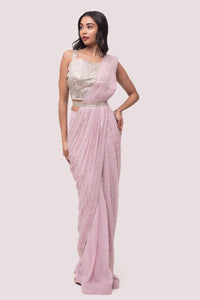Shop the pink mirror work saree with a sleeveless blouse. Make a fashion statement on festive occasions and weddings with designer sarees, designer suits, Indian dresses, Anarkali suits, palazzo suits, designer gowns, sharara suits, and embroidered sarees from Pure Elegance Indian fashion store in the USA.