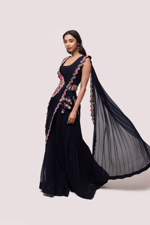 Shop navy blue saree with faux half jacket blouse. Make a fashion statement on festive occasions and weddings with designer sarees, designer suits, Indian dresses, Anarkali suits, palazzo suits, designer gowns, sharara suits, and embroidered sarees from Pure Elegance Indian fashion store in the USA.